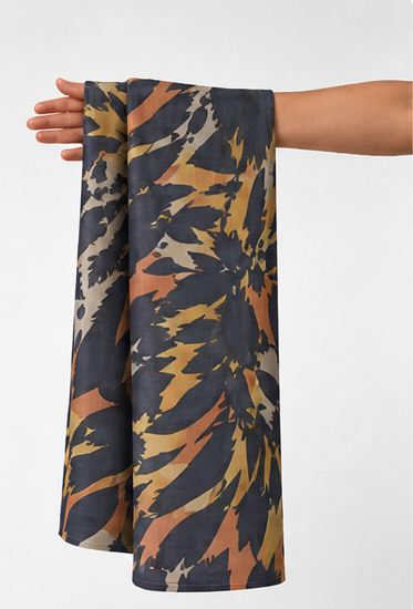 Tan Navy Abstract Animal Print chiffon held in hand for scale
