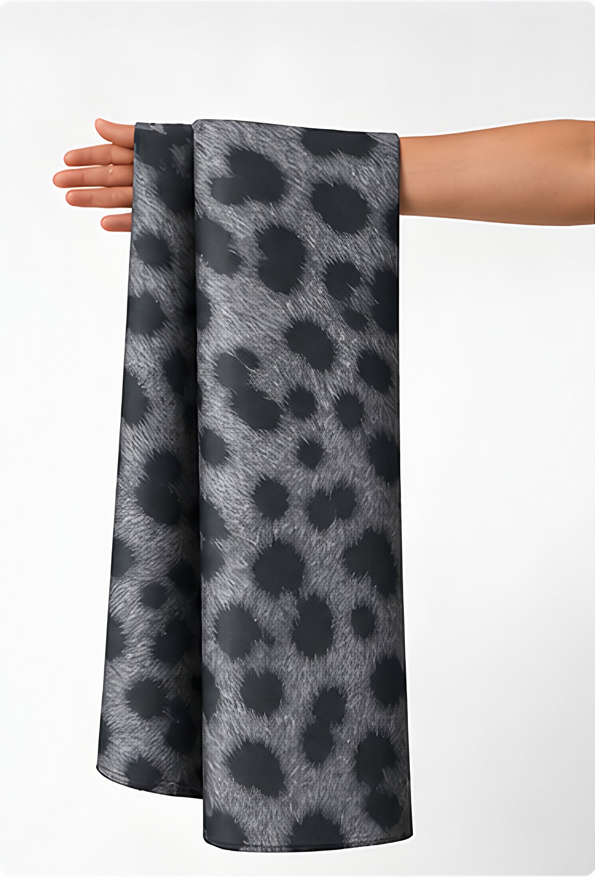 Grey Leopard Spot chiffon held in hand for scale