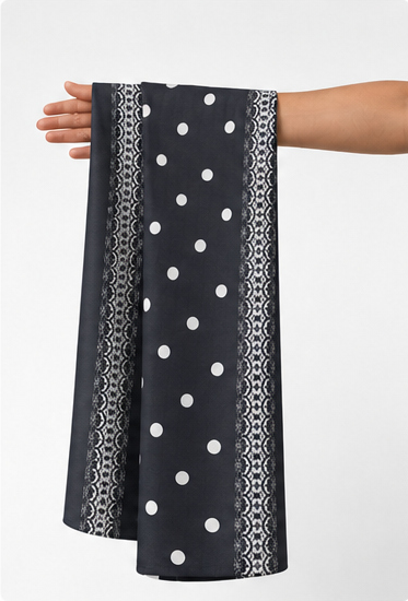 Black Polka Dot Border crepe held in hand for scale