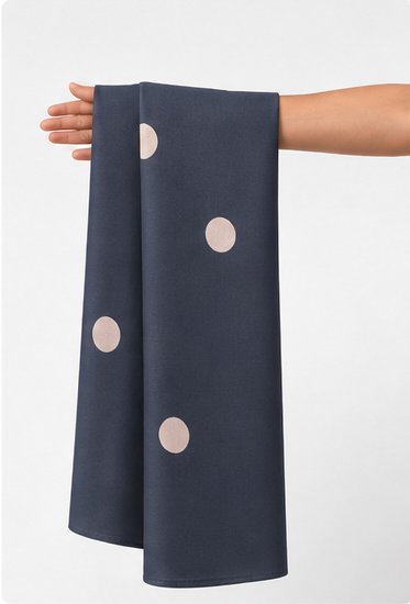 Charcoal Beige Polka Dots crepe held in hand for scale