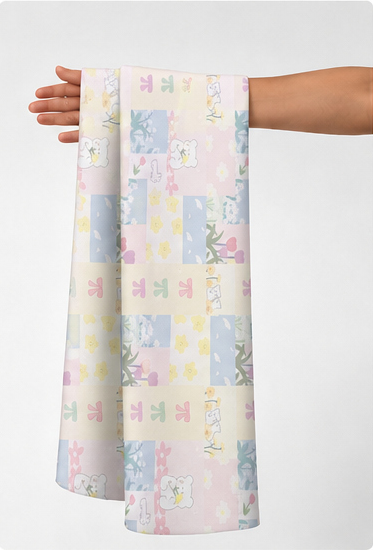 Pastel Floral Patchwork poly-cotton held in hand for scale