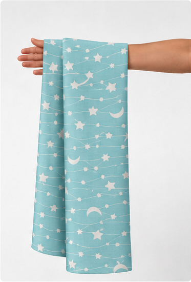Turquoise Moon and Stars poly-cotton held in hand for scale