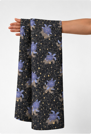 Midnight Violet Floral Stars poly-cotton held in hand for scale