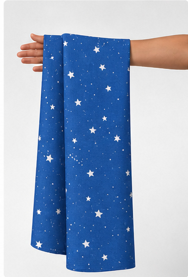 Royal Blue Starry Sky poly-cotton held in hand for scale