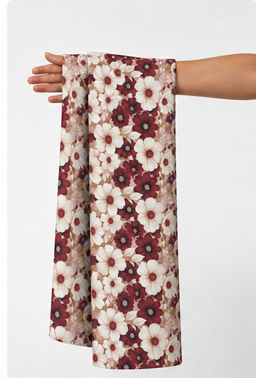 Burgundy Ditsy Daisy Floral poly-cotton held in hand for scale