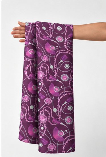 Plum Pink Floral Swirls poly-cotton held in hand for scale