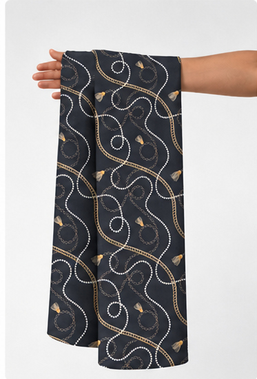 Charcoal Beige Floral Spirals poly-cotton held in hand for scale