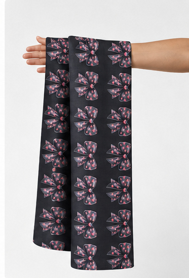 Charcoal Pink Botanical Motifs poly-cotton held in hand for scale