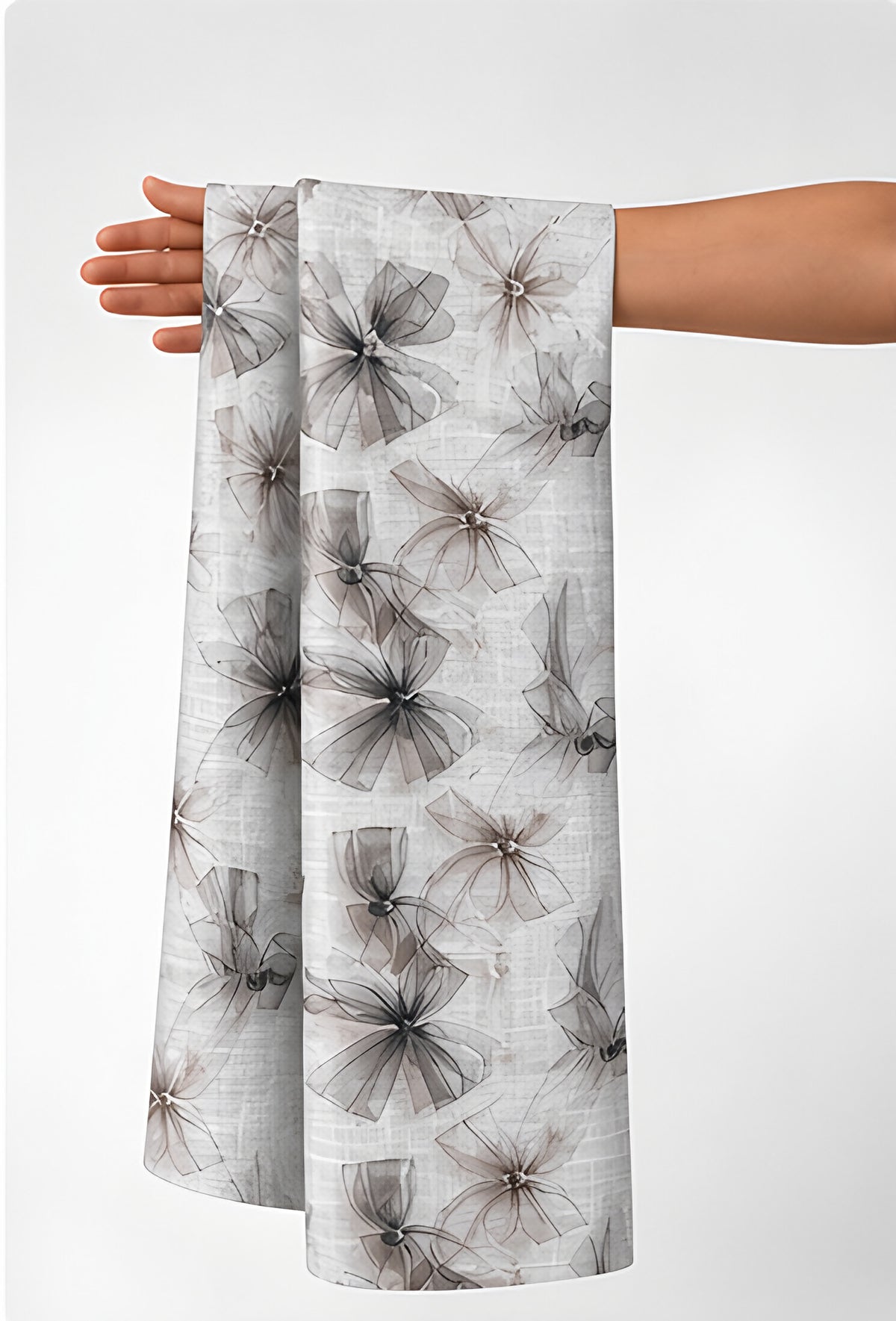 Ivory Grey Feathered Botanical poly-cotton held in hand for scale