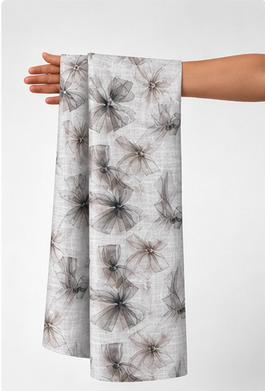Ivory Grey Feathered Botanical poly-cotton held in hand for scale