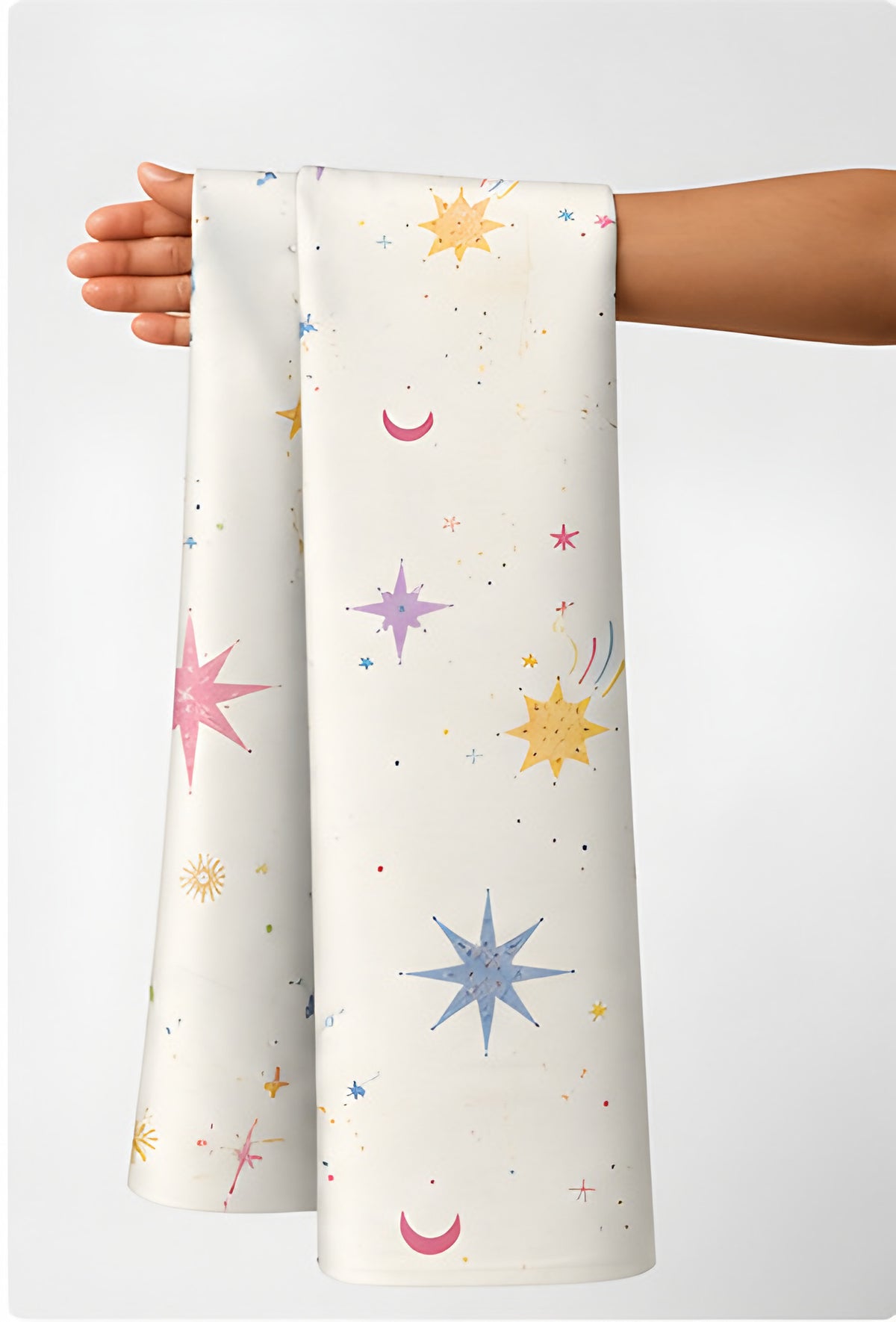 Ivory Pastel Stars and Suns poly-cotton held in hand for scale