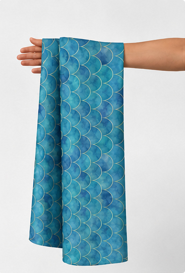 Ocean Blue Botanical silk held in hand for scale
